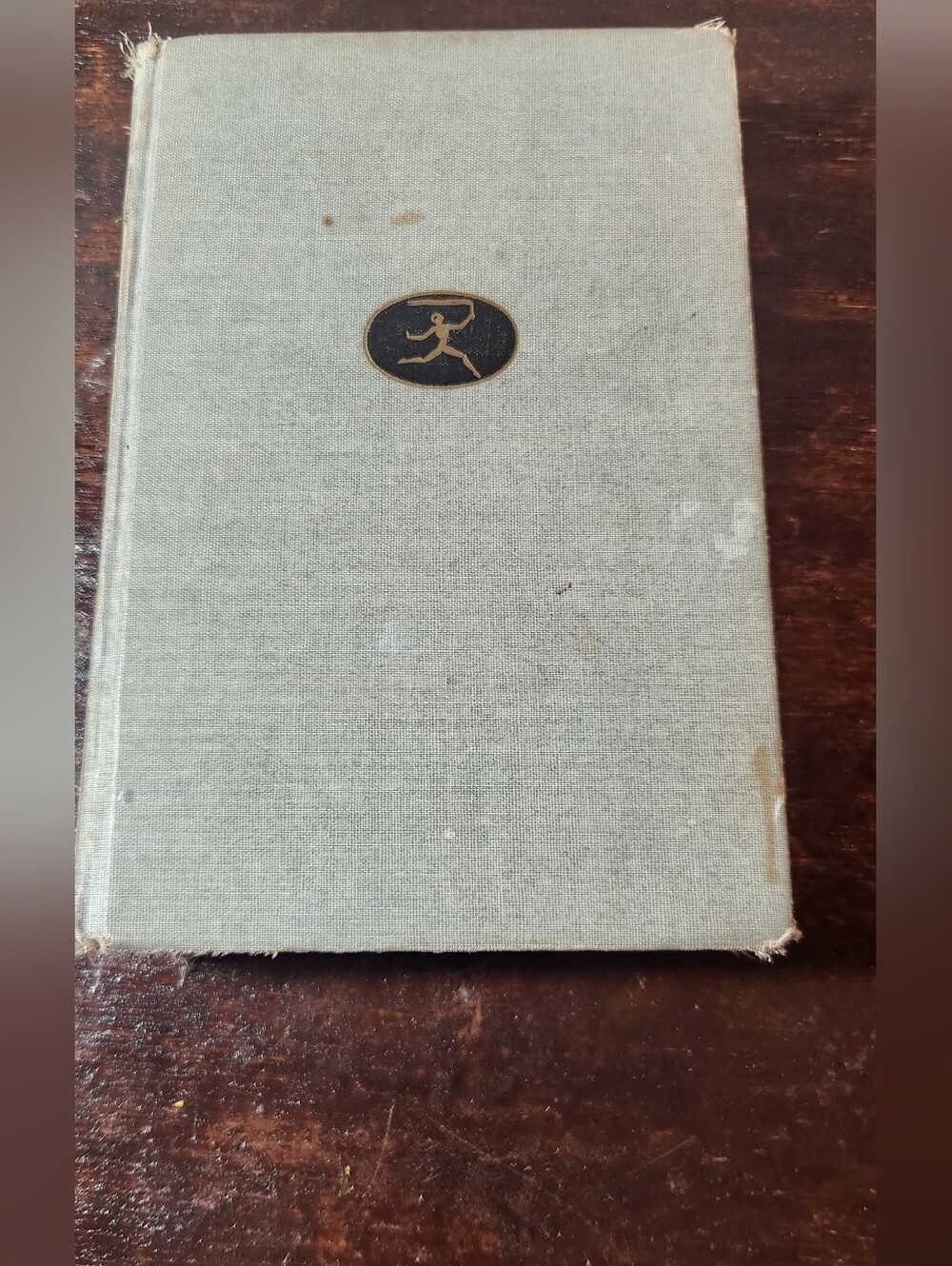Vintage Light Gray Clothbound Book with Gold Emblem